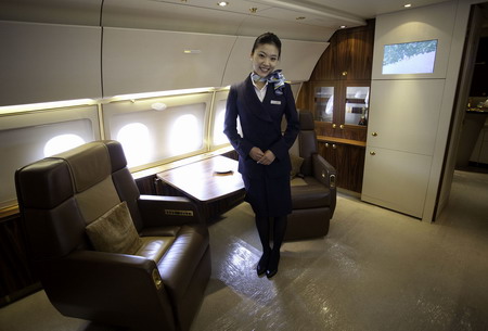 Flight attendant Jane Chu poses for a photograph in EADS Airbus A318 Elite business jet displayed on the tarmac of the Business Aviation Center during the Asian Aerospace International Expo and Congress in Hong Kong, China, on Wednesday, March 9, 2011. Asian Aerospace 2011 takes place over 3 days in Hong Kong from March 8 to 10. Photographer: Jerome Favre/Bloomberg *** Local Caption ***